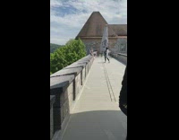 White shirt lady sits on prohibited wall 