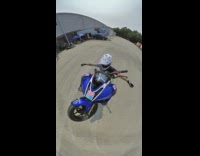 Guy does wheelie on motorcycle with no hands 