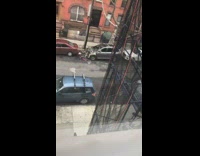 Car's engine and front window destroyed, parked on the side street