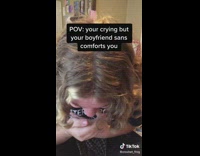 Guy comforting crying girlfriend with skeleton arm hand