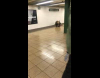 Rat costume mask guy crouches subway station 