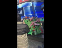 Men in green suits red nose pose for picture on the street