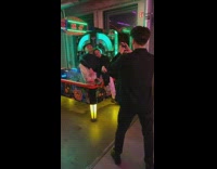 Couple poses on air hockey table 