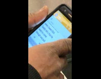 Guy texts in big font on cellphone screen "Sweet dick daddy" on subway train