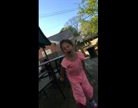 pink jumpsuit little girl yells loudly outside