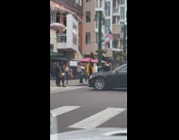 Black dress girl poses by red curb 