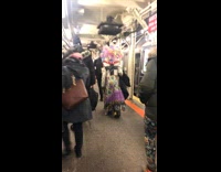 Rainbow tissue hair quilt dress woman walks around subway station