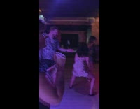 People dances in the club with a man faces the wall