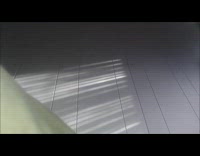 man beanie grey shirt throws colorful ball at camera