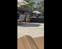 Woman black bikini pool ledge fedora hat