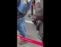 Rat crawls around people in line for tickets 