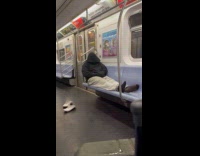Man jacket hoodie occupies seat inside train