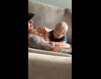 Baby try to bite nipple of dad