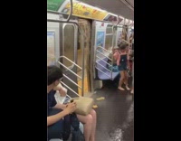 Water leaks out of roof of subway station and floods inside open train doors