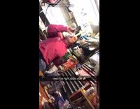 Girl takes a swig of vodka and holds bottle of Sprite in her hand