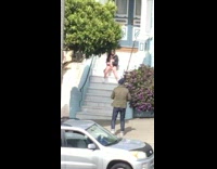 Girl sits on white stairs blue house 