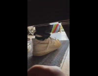 Guy hides under couch to scare friend