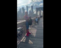 Spiderman on bridge about to wear backpack