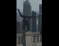 Black jacket handstand guy city skyline
