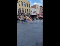 Man ride bike balance basketball on head