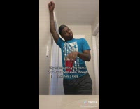 Guy stirs red solo cup in bathroom