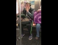 Man headphones green ipad dancing sitting subway train 