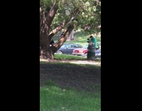 Girl black sleeves skirt pose near tree.