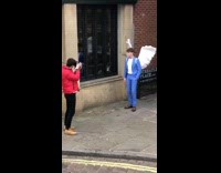 Guy wears blue suit and white wings 