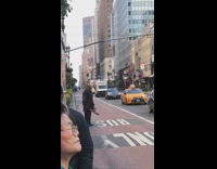 Person walking through bus only lane new york in scary costume machete mask