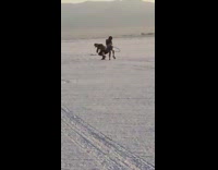 Collab Kook Of The Day - Man records woman dance with hula hoop in open desert grounds