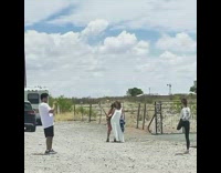 Two Ladies Pose with a Selfie Stick while Another Does a Yoga Pose 