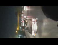 Brown car reverse drive busy road nighttime