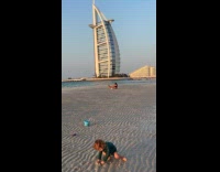 Woman bikini yoga pose near Burj Al Arab