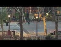 two people play fight in empty basketball court