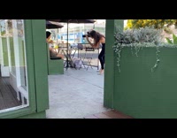Woman in white crop top poses with a coffee drink