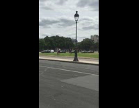 Black dress girl dances friends watch grass