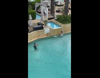 Woman Poses for Photos at Resort Pool Hot Tub Waterfall