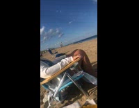 Woman bikini bend and raise arms on lifeguard chair