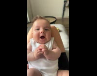 Baby white top lay on lap talks