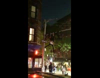 Two guys hang metal pole hold girl