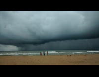 Large grey cyclone storm cloud over ocean 