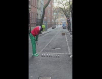 Guy hits box on street with club 