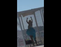 Girl white swimsuit climb hang metal rails