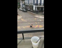 White shirt girl sits road arm tattoo 