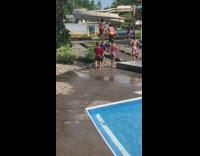 Little boy walking with girl holds hands and gets help from kid in blue