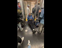 Collab WINY - Man in blue jacket sleeps on foldable chair inside train