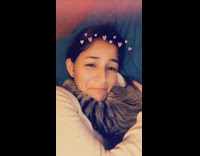 Sleeping cat cuddles and hugs woman around her neck, woman scratches and kisses its head