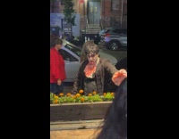 Guy in bloody costume waves at pub