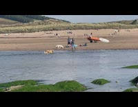 Two people pump air into kayak or raft