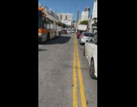 Guy crosses traffic walks to cardboard condo